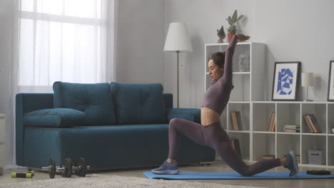 Yoga-Praxis-Zu-Hause.-Junge-Frau-Führt-Asana-Training-Im-Wohnzimmer-Durch-Und-Streckt-Beine-Und-Hände,-Muskeln-Und-Einen-Gesunden-Lebensstil